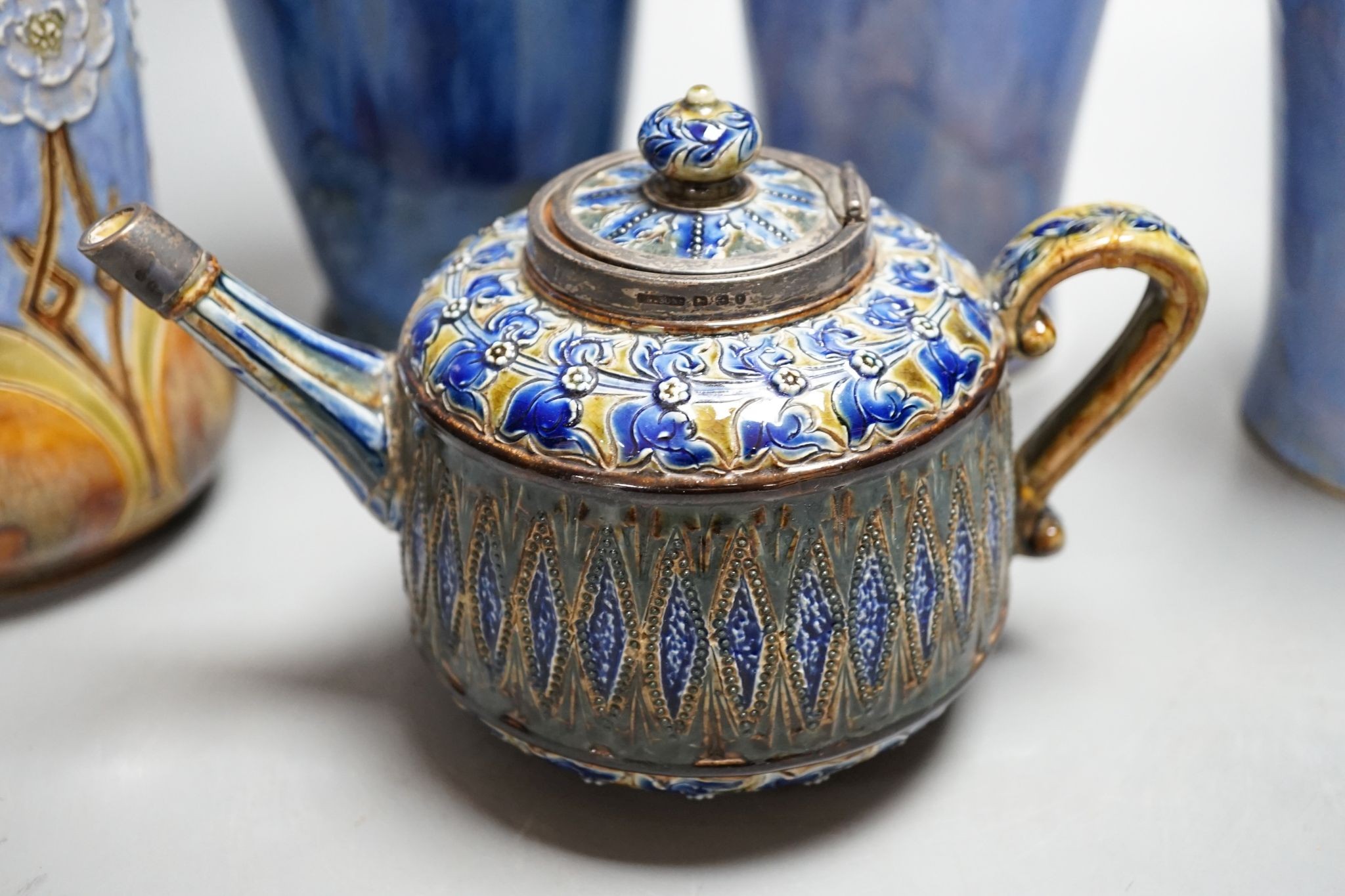 A Doulton teapot and four Doulton vases, 26cm